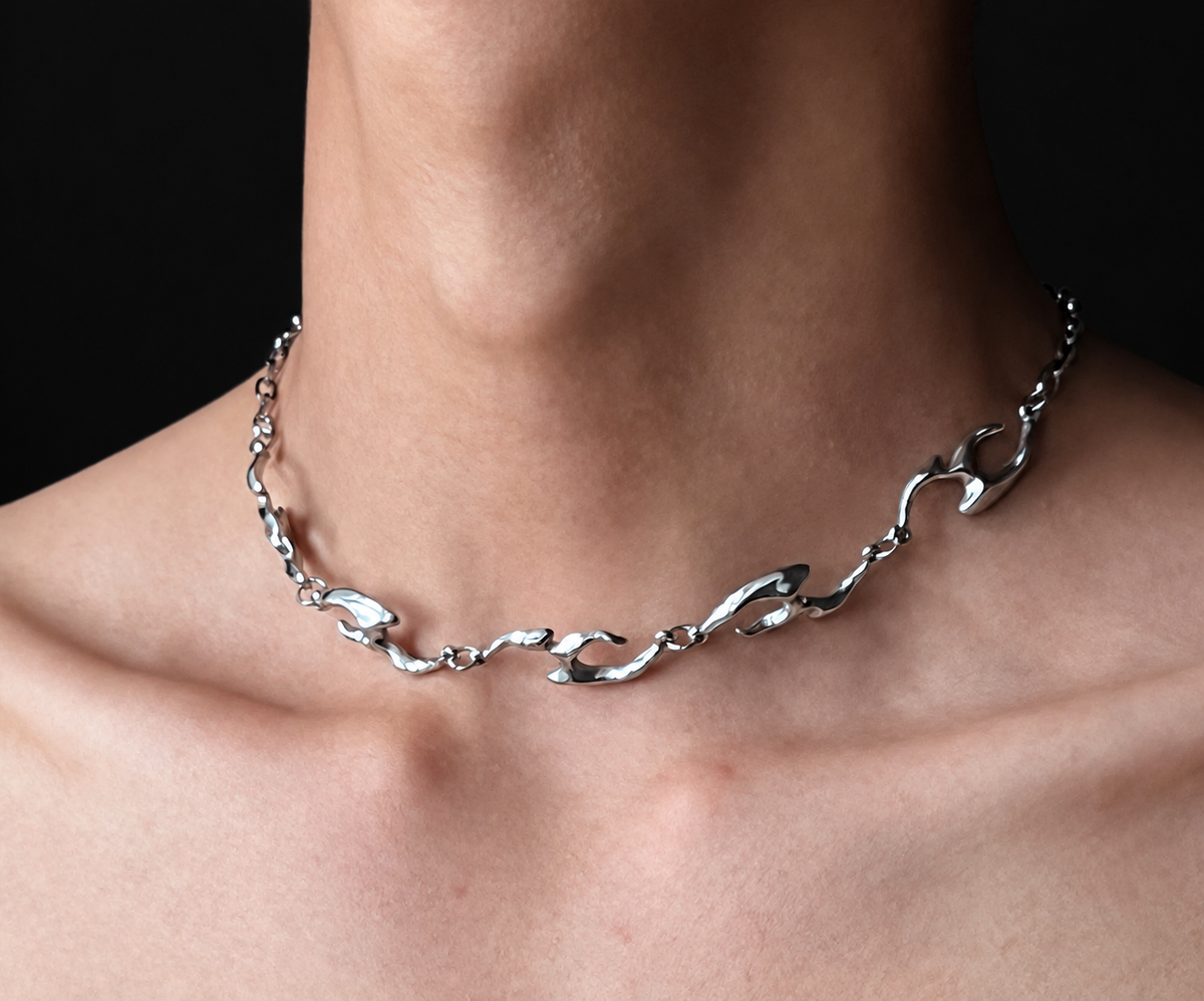 Erebus men's sterling silver flame-link necklace worn at the collarbone