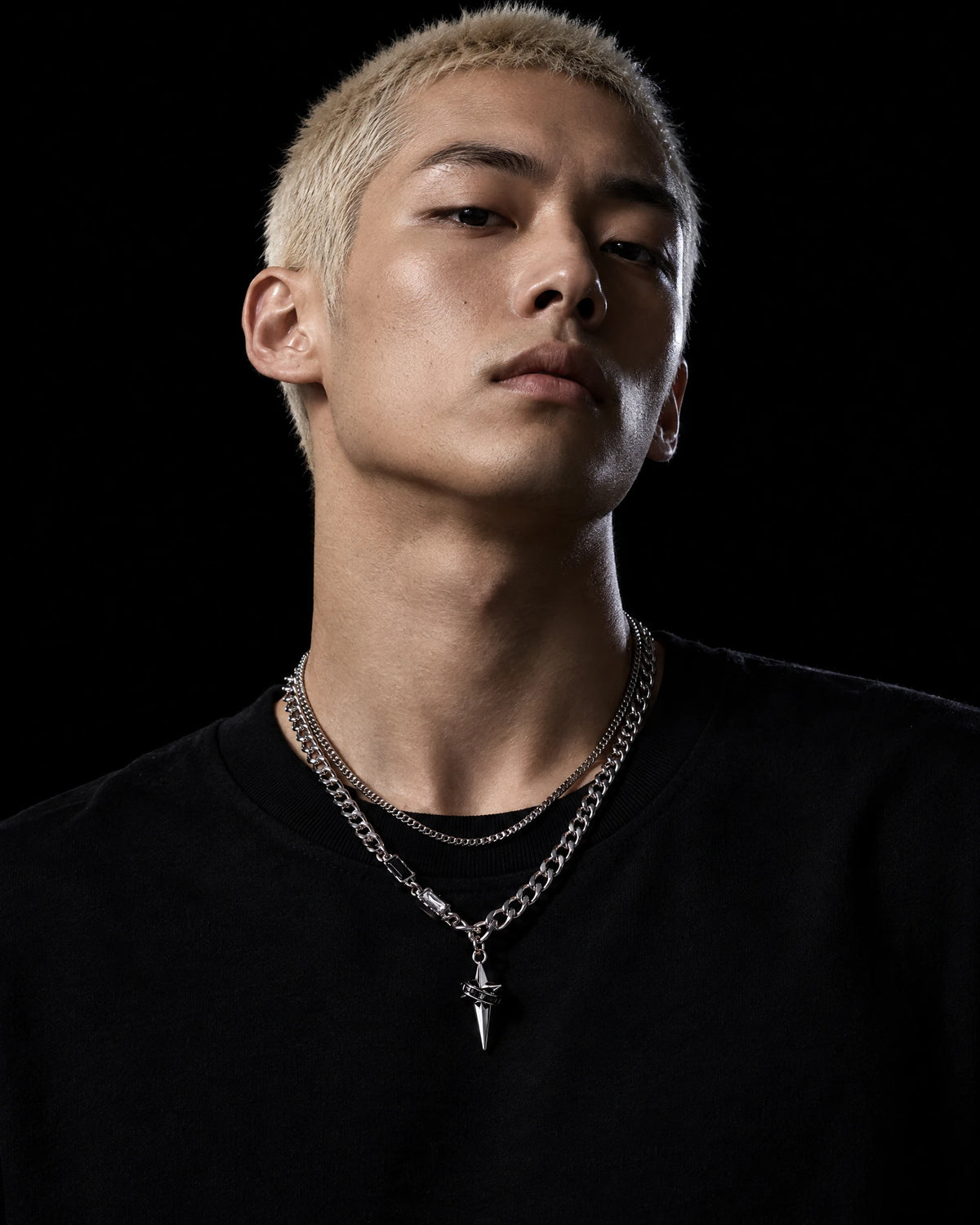 Astraea jewelry worn by a model in black streetwear.