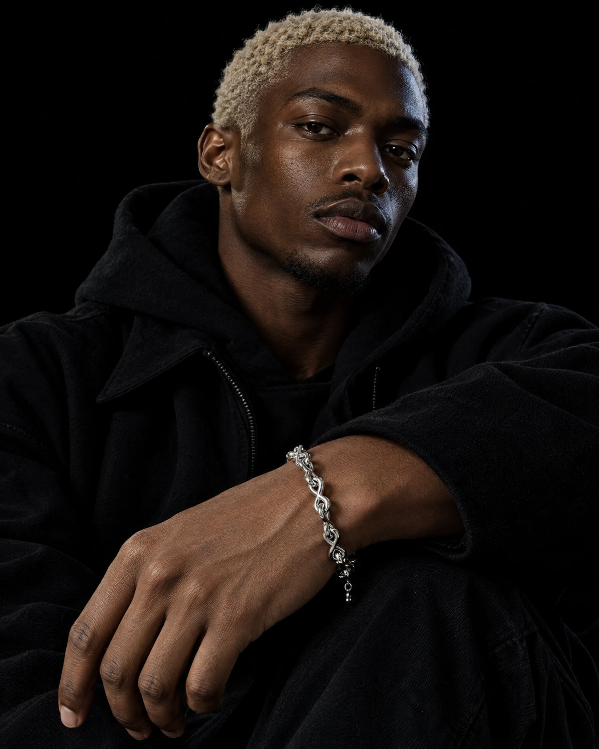 Charon jewelry worn by a model in black streetwear.