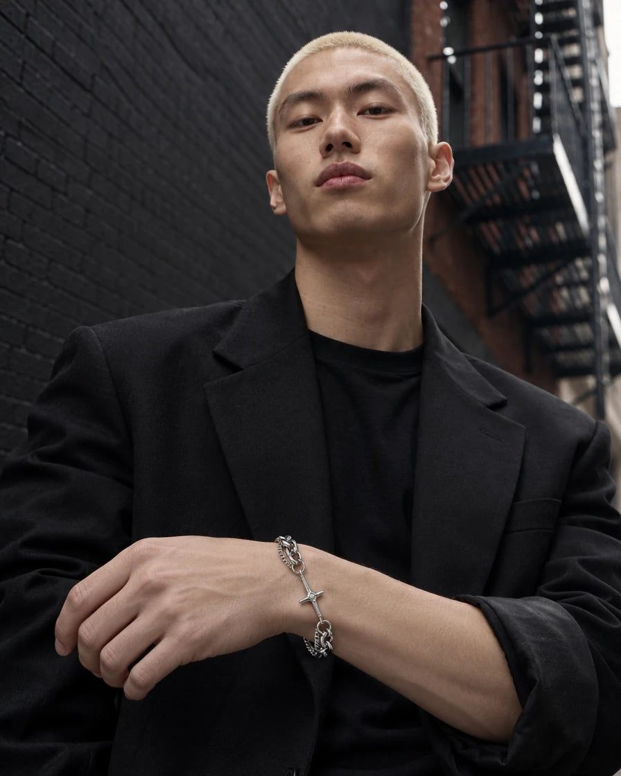 Hades jewelry worn by a model in black streetwear.