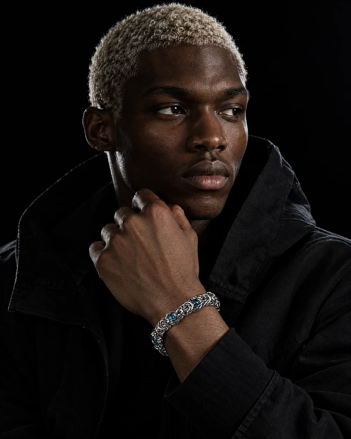 Styx jewelry worn by a model in black streetwear.
