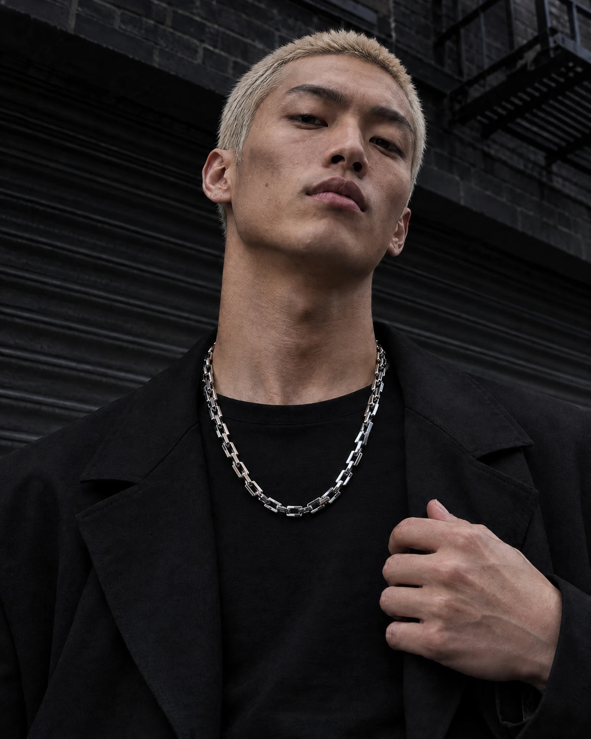 Tartarus jewelry worn by a model in black streetwear.