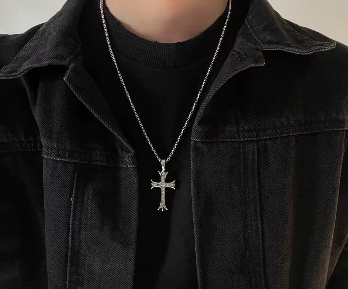 Aether cross pendant necklace worn over a black tee