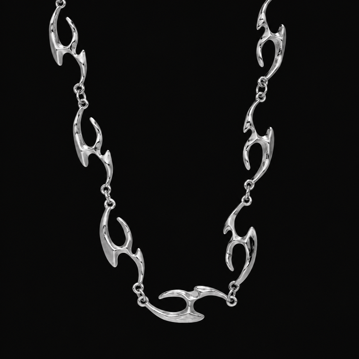 Erebus sterling silver flame-link necklace laid flat on black