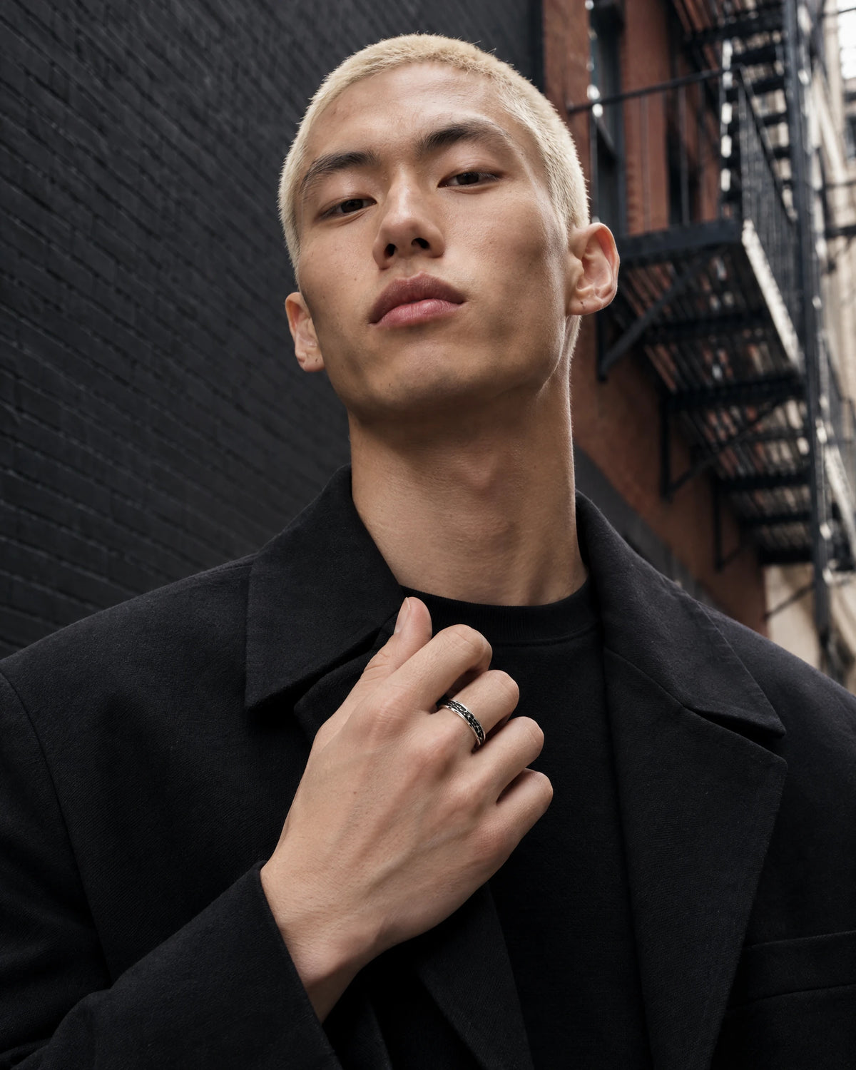 Chaos jewelry worn by a model in black streetwear.
