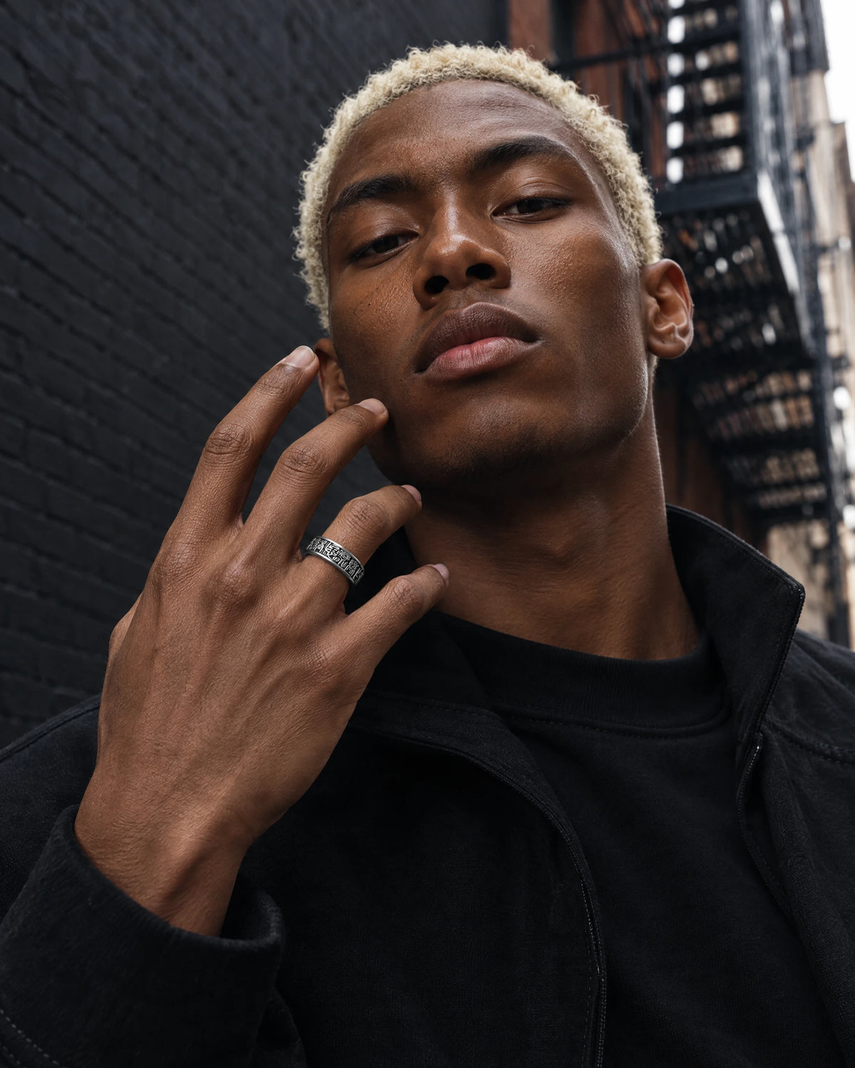 Fortuna jewelry worn by a model in black streetwear.