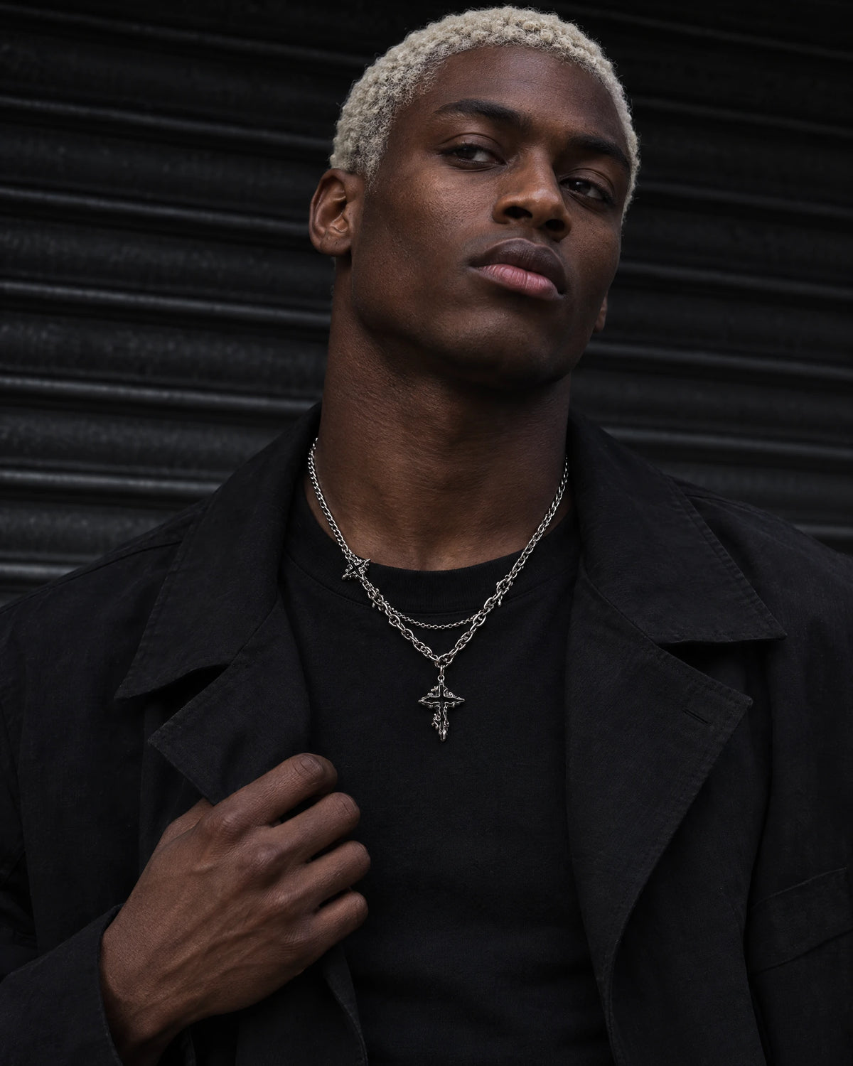 Hypnos jewelry worn by a model in black streetwear.