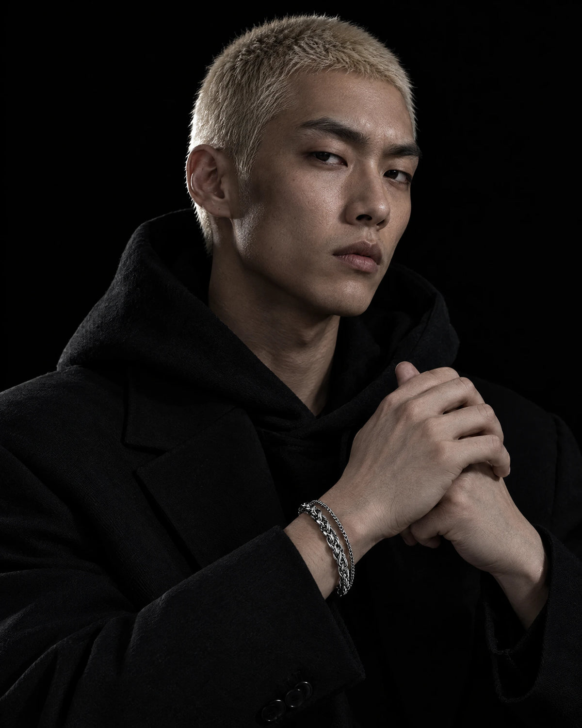 Orcus jewelry worn by a model in black streetwear.