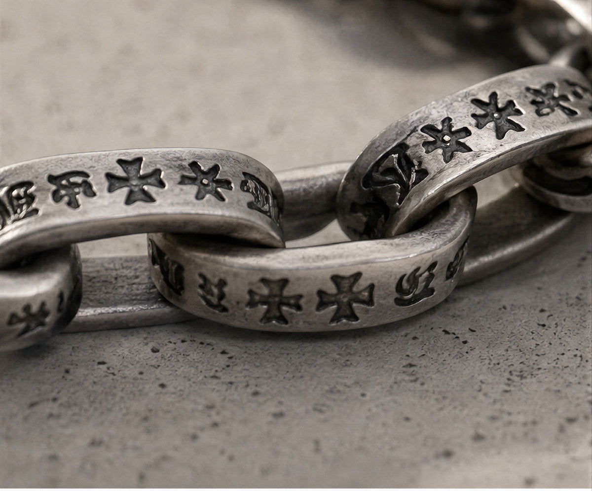 Pluto engraved cross links in oxidized sterling silver, macro detail