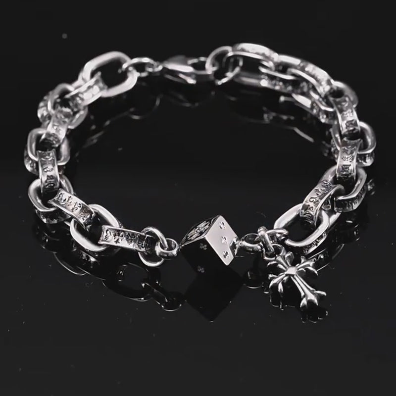 Tyche engraved link bracelet with dice and cross charms, rotating