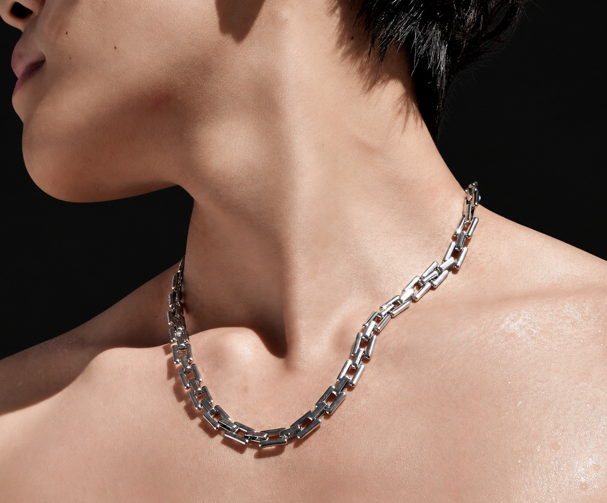 Tartarus sterling silver geometric necklace worn against a dark background
