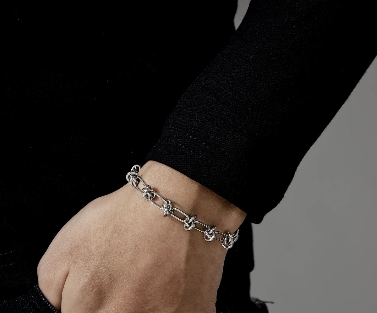 Nemesis polished silver chain bracelet with angular texture
